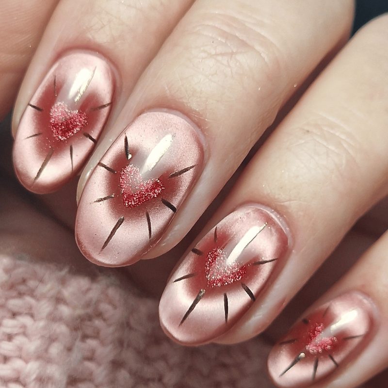 close-up hands applying fall nail art stickers with nail tools