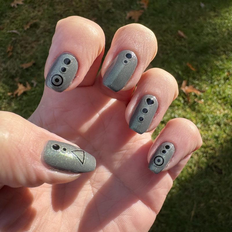 close-up of hands applying gel nail art paint with fine brush