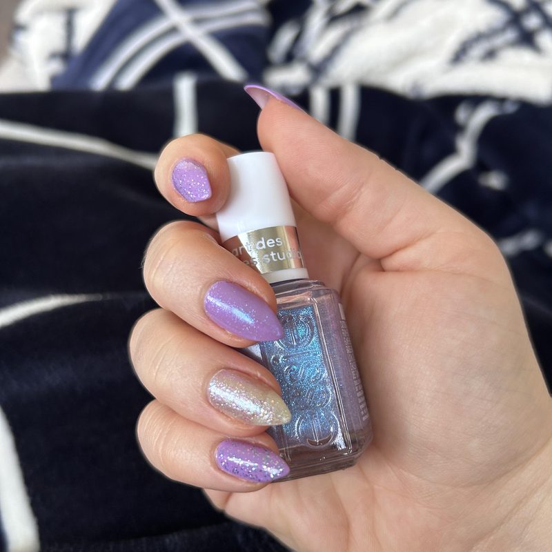 Close-up of hands applying special effects polish with a flat nail art brush