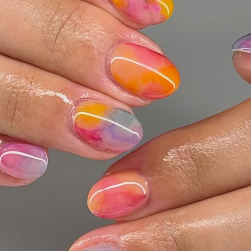 close-up of hands showing abstract nail art design techniques