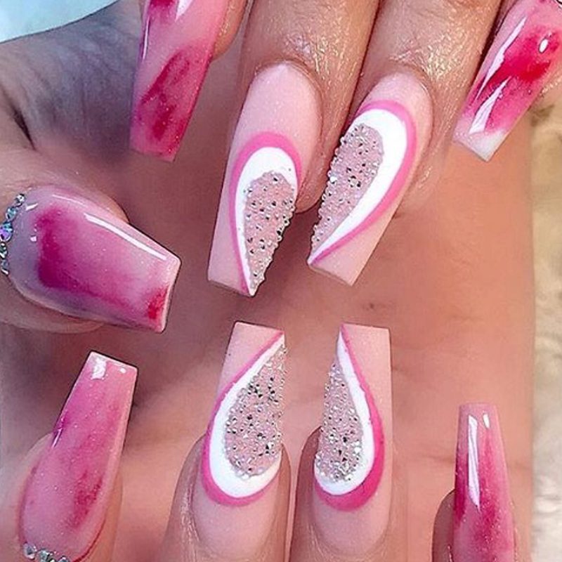 close-up of trendy prom nail art designs with glitter and rhinestones