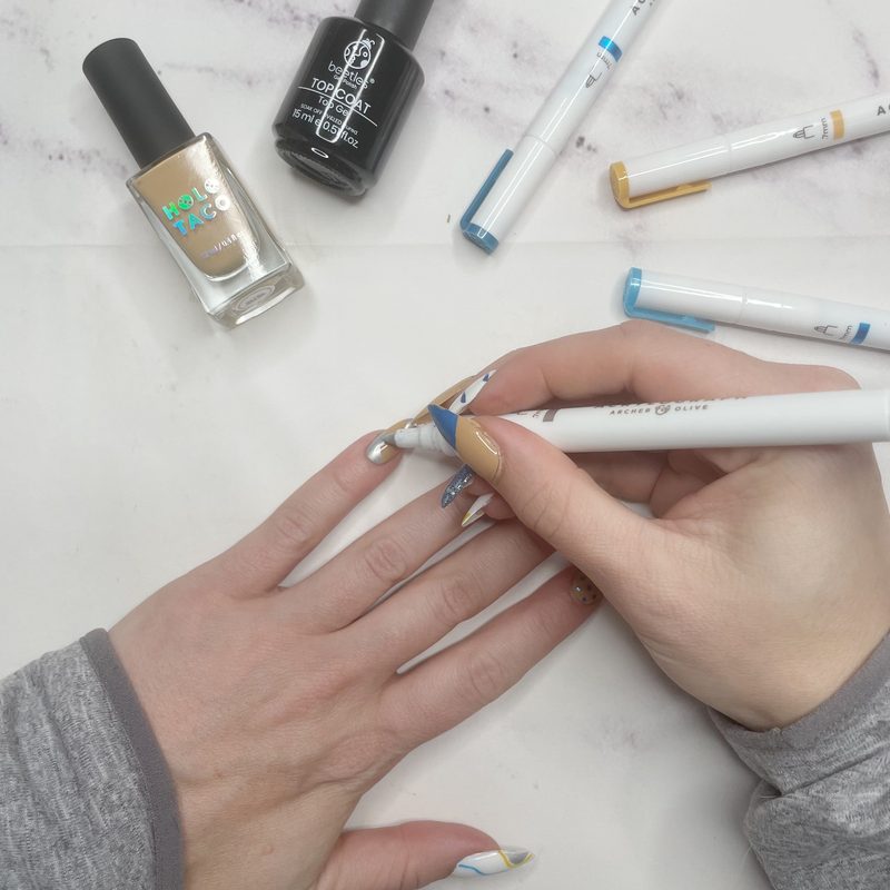 Colorful gel nail art pen designs featuring florals and geometric patterns