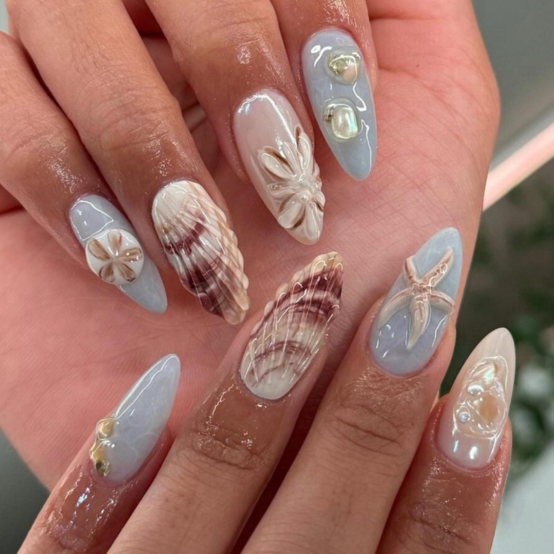 hands applying nail art water transfer stickers during DIY manicure