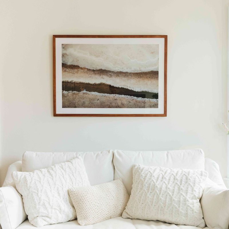 Modern rental apartment wall decorated with art hung using damage-free wall hooks