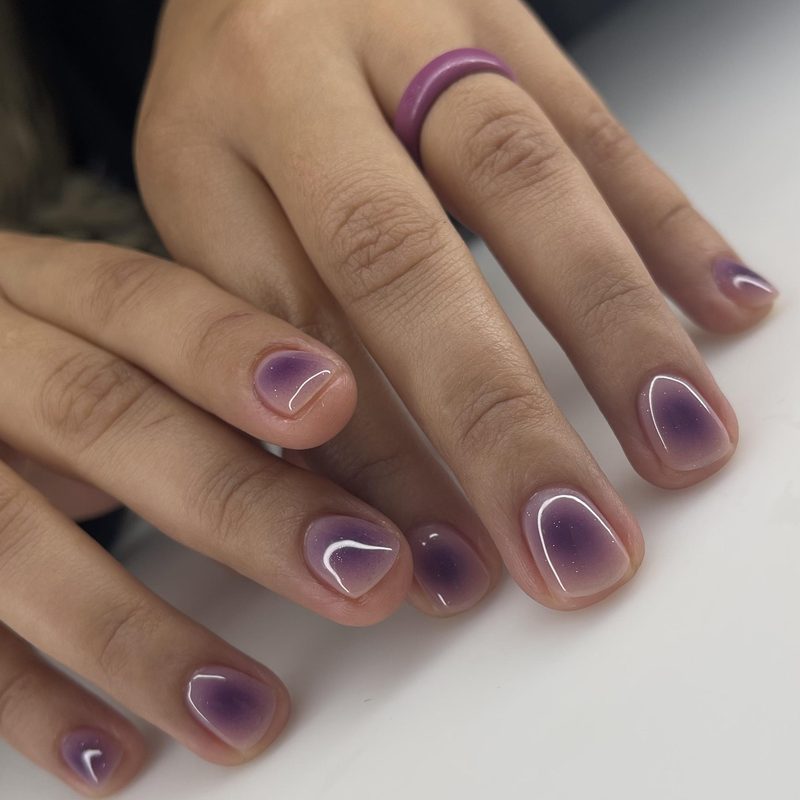 nail technician showing nail anatomy to client during salon visit