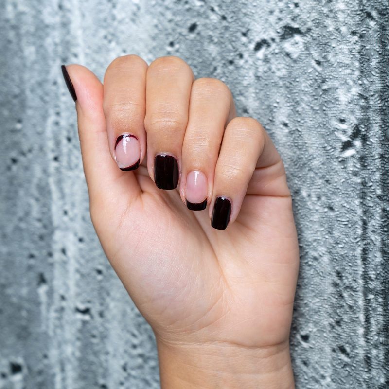 nails painted in fall colors with coordinating nail art stickers