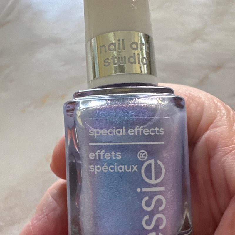 Nails painted with holographic and metallic Essie nail art special effects
