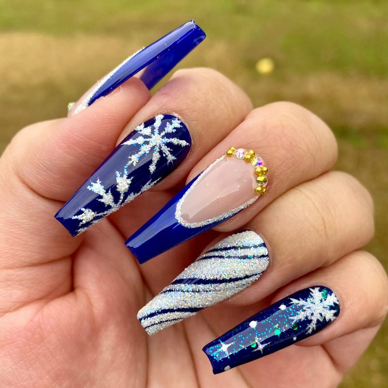 professional nail artist applying glitter nail polish in a salon setting