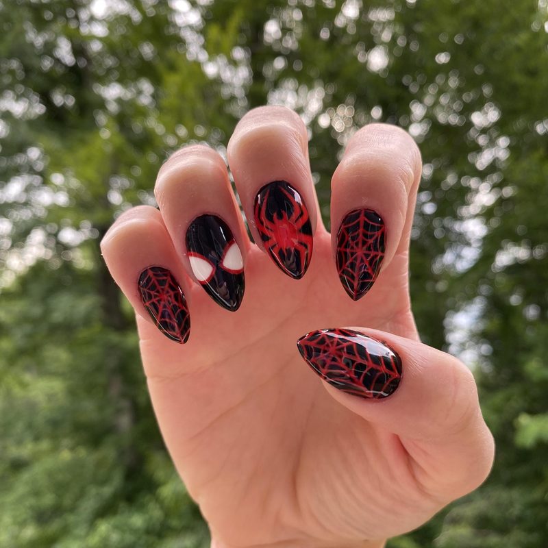 applying spider gel for nail art with a thin brush