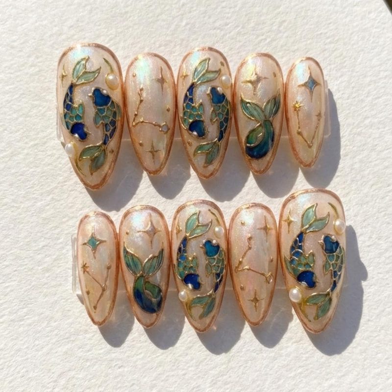 Bold Pisces nail art with fish scale patterns and celestial motifs