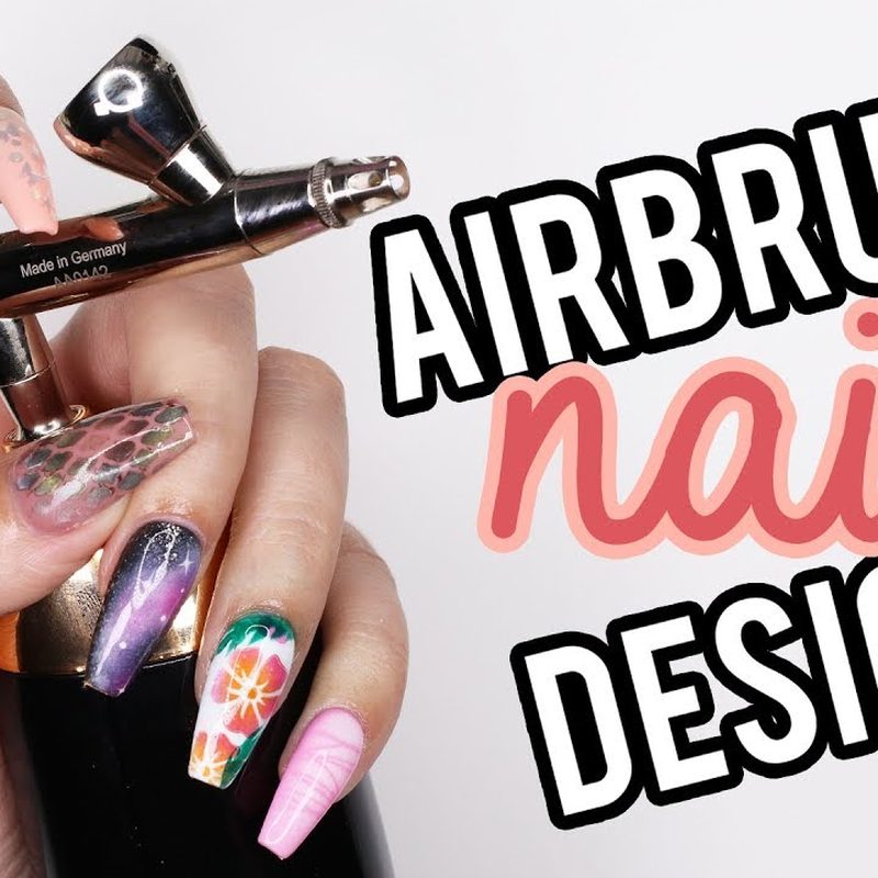 close-up of airbrush nail art being applied with stencil