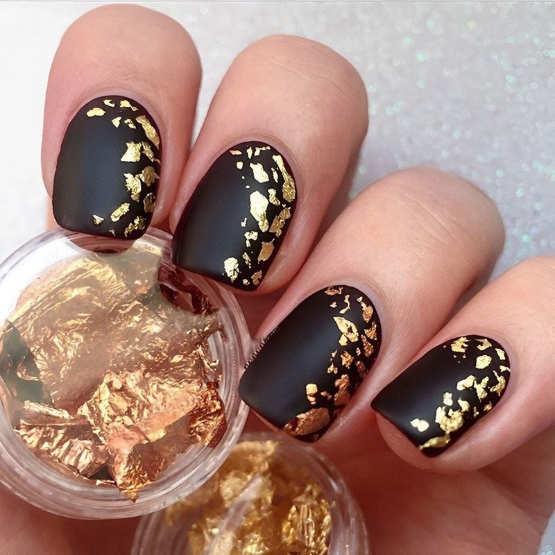 close-up of colorful foil nail designs with metallic finishes