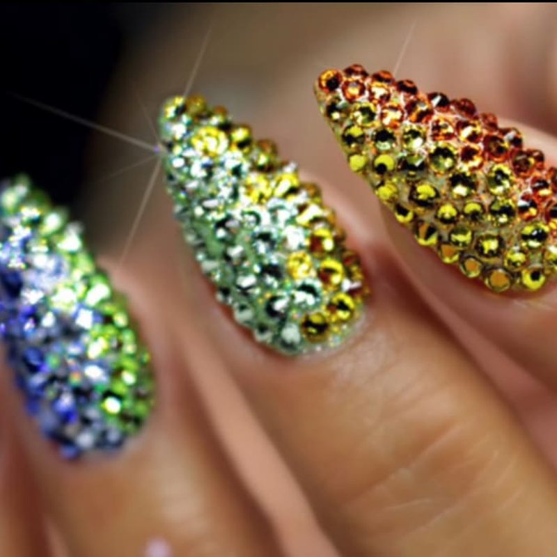 close-up of crystal nail embellishments sparkling under light