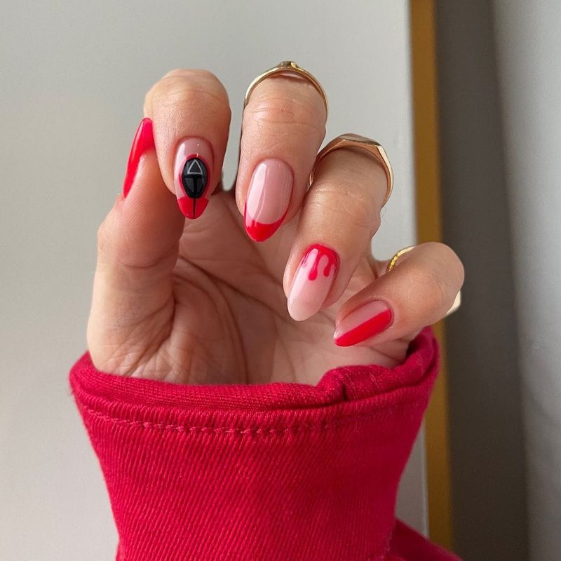 Close-up of gel squid game nails art with glossy finish and bold shapes