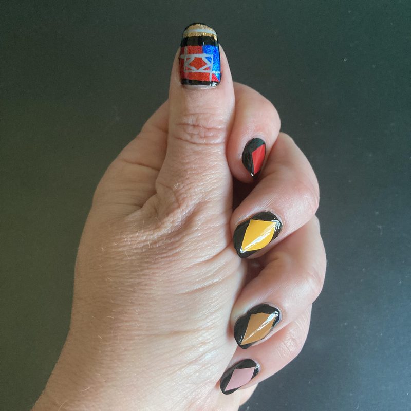 close-up of geometric nail art showcasing bold color blocking techniques