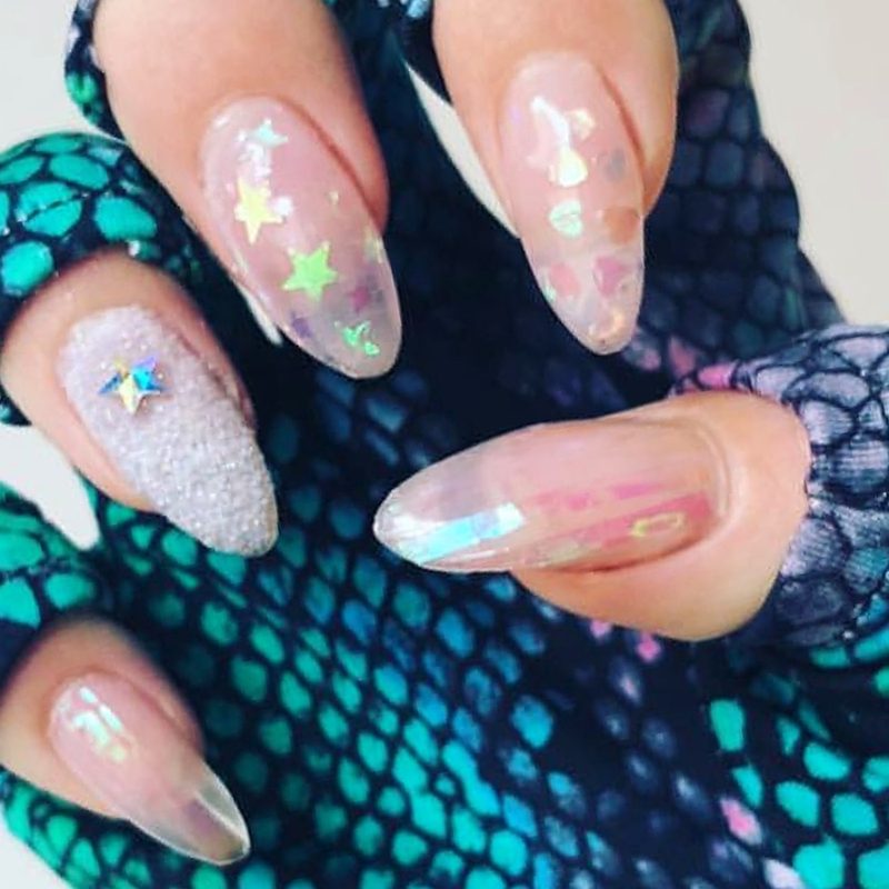Close-up of hands wearing gloves to protect foil nail designs