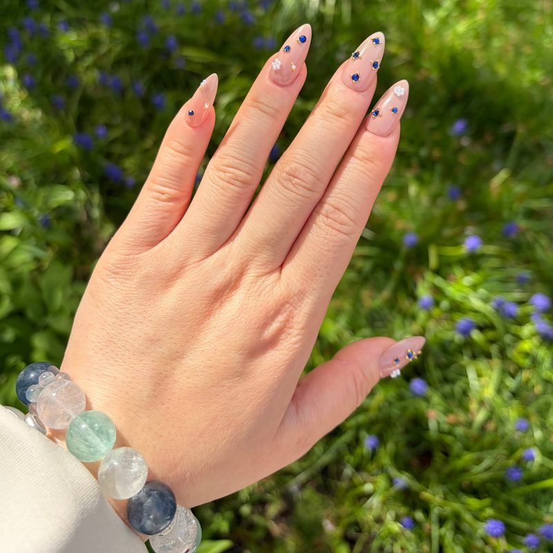 Close-up of Swarovski crystals highlighting nail art charms