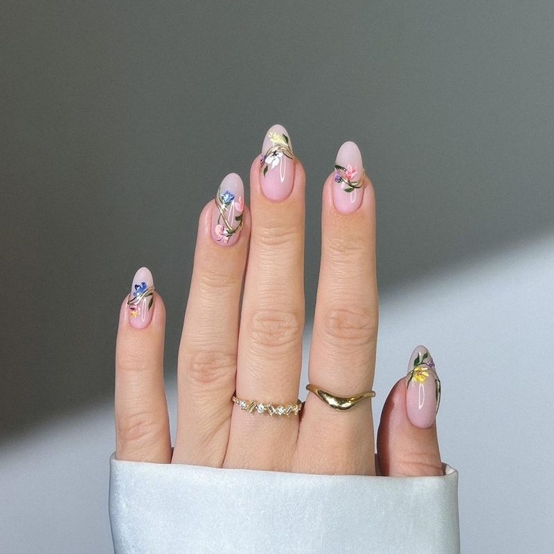 Close-up of trendy nude nails with rhinestone embellishments