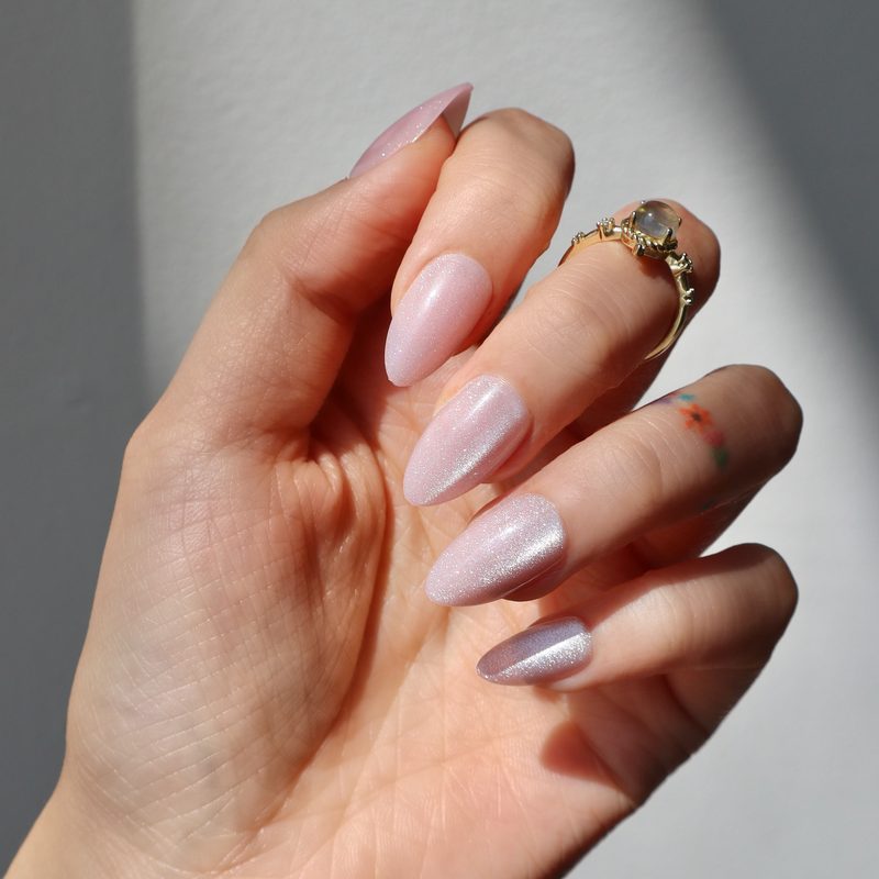 gel nails featuring detailed breast cancer ribbon nail art using nail art pen