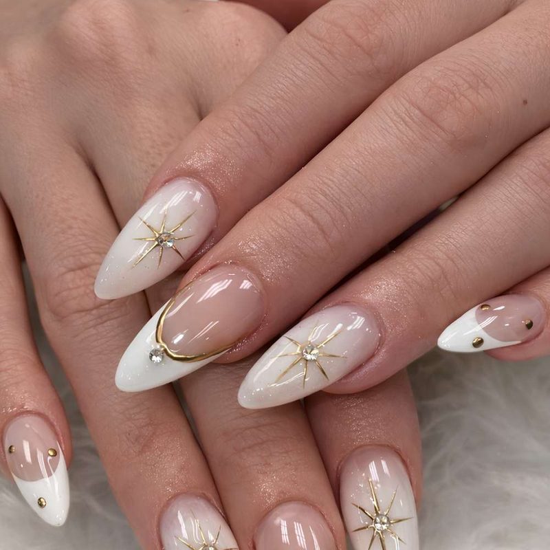 hands showing trendy white nail art polish designs with geometric patterns