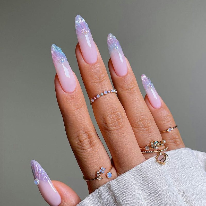 Minimalist Pisces nail art with pastel colors and glitter accents