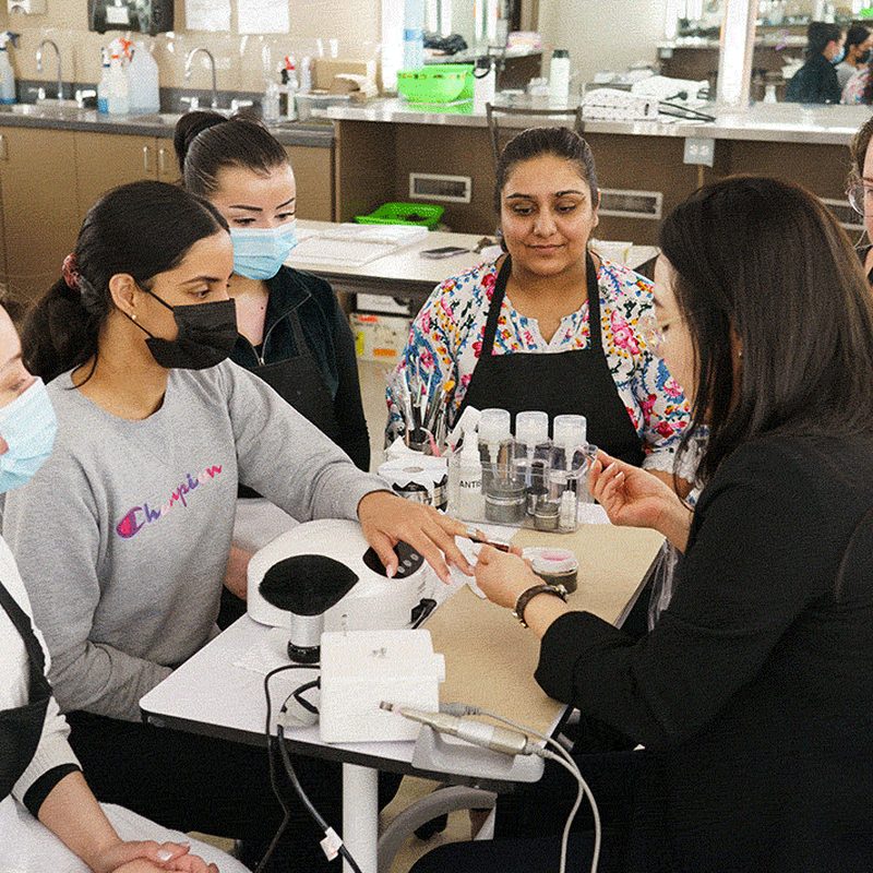 Nail art course classroom with professional instructor teaching