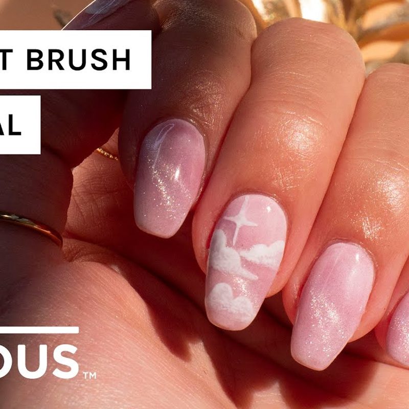 Nail artist demonstrating gradient nail art technique with a flat brush