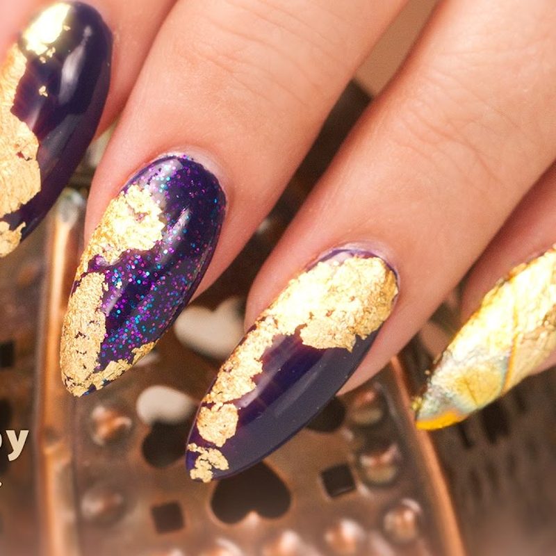 nail technician applying foil nail art adhesive on client's nails