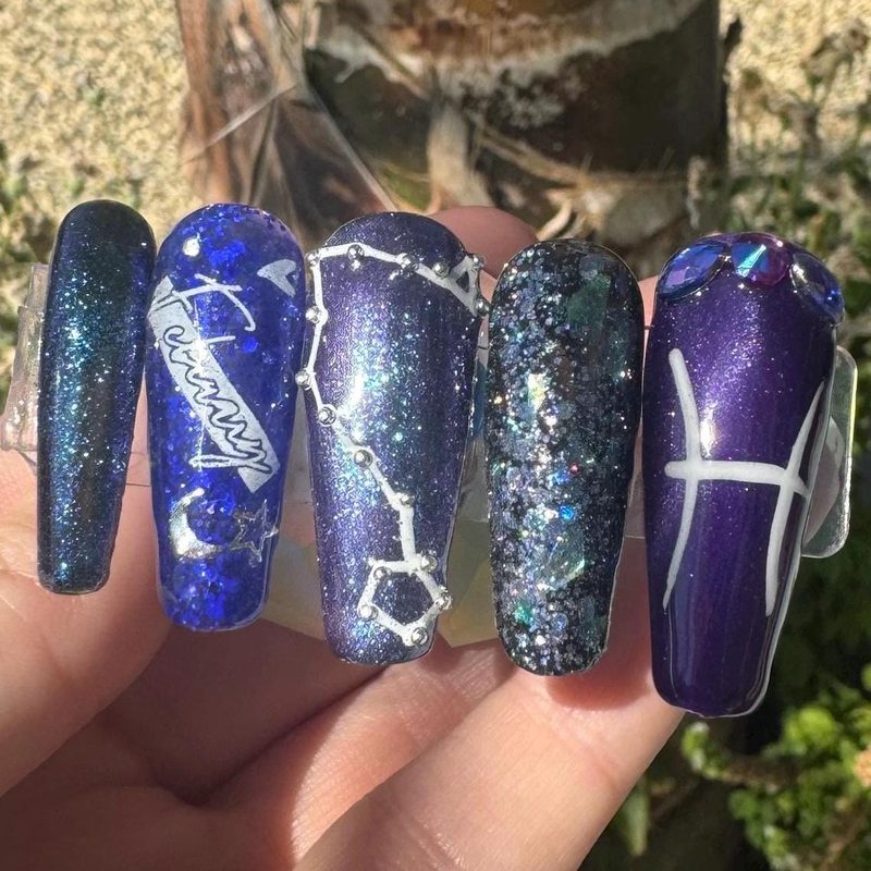 Pisces zodiac symbol nail art with water-inspired colors