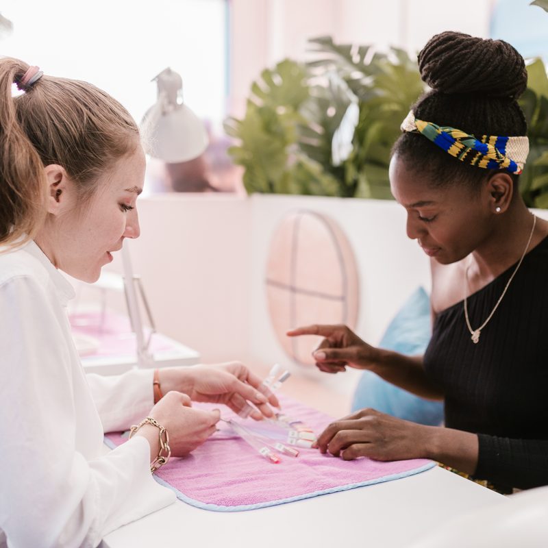 students practicing professional nail art training in a classroom