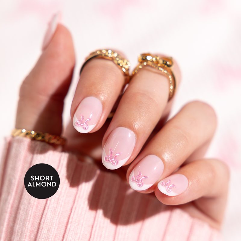 variety of pink ribbon nail art styles with different designs and embellishments