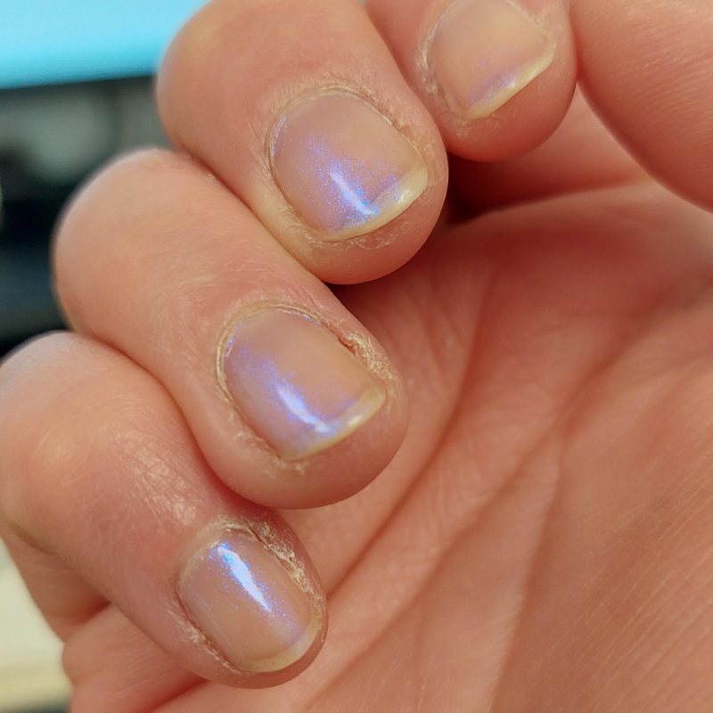 well-maintained nails with glossy topcoat showing nail art longevity