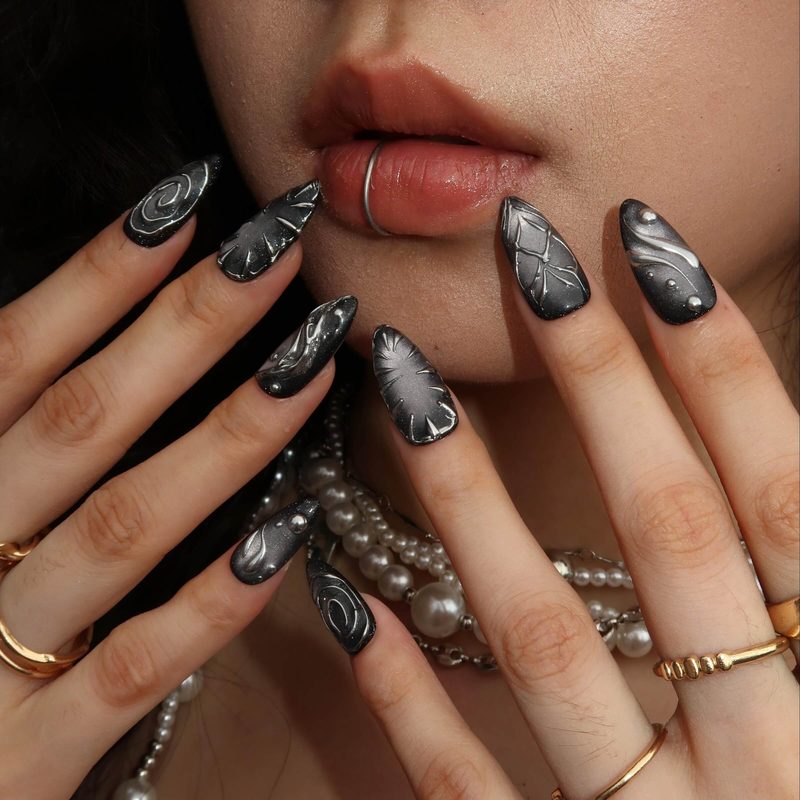 black matte nails with metallic gold nail art accents