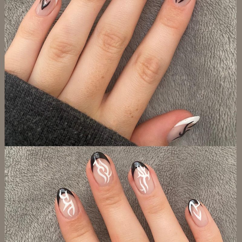 close-up of a hand with simple tribal nail patterns in black and white