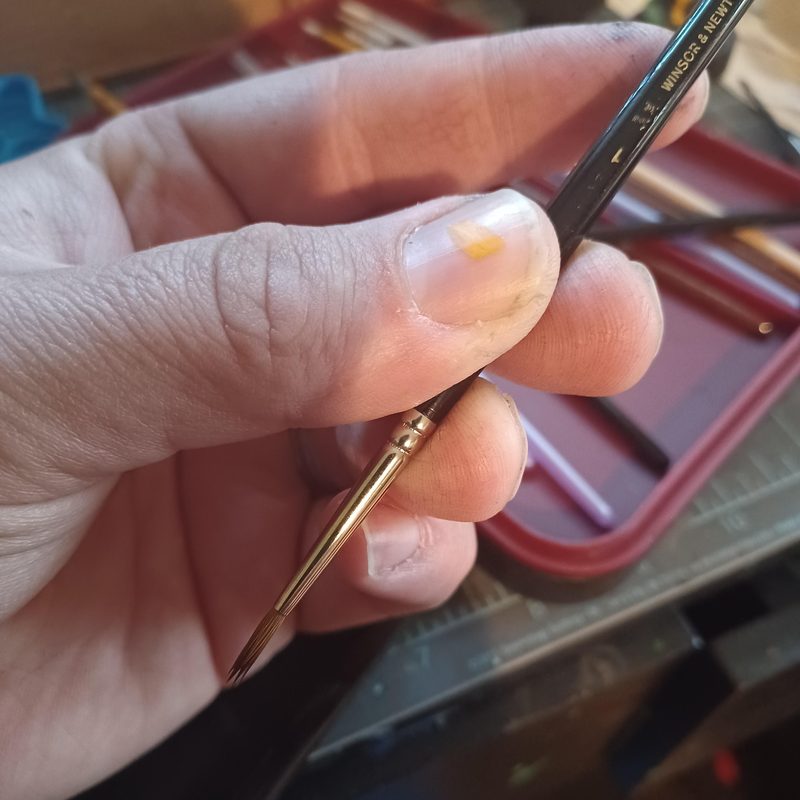 close-up of a Kolinsky sable nail art liner brush showing fine tip