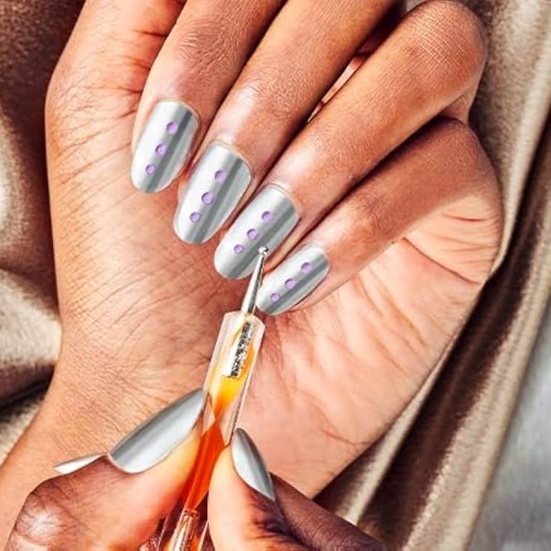 close-up of professional nail art tools including brushes and dotting tools