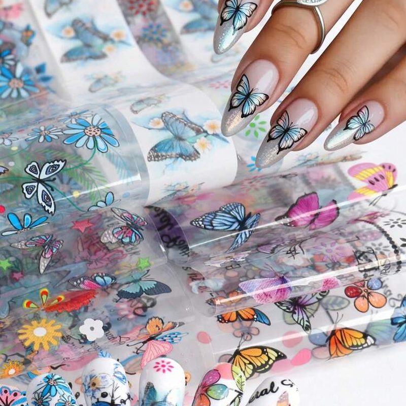 Colorful nail art transfer foil sheets showing different patterns and metallic textures