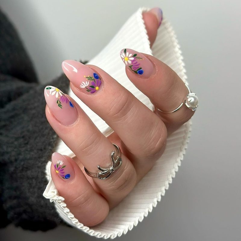 delicate floral nail art painted with thin brush on natural nails