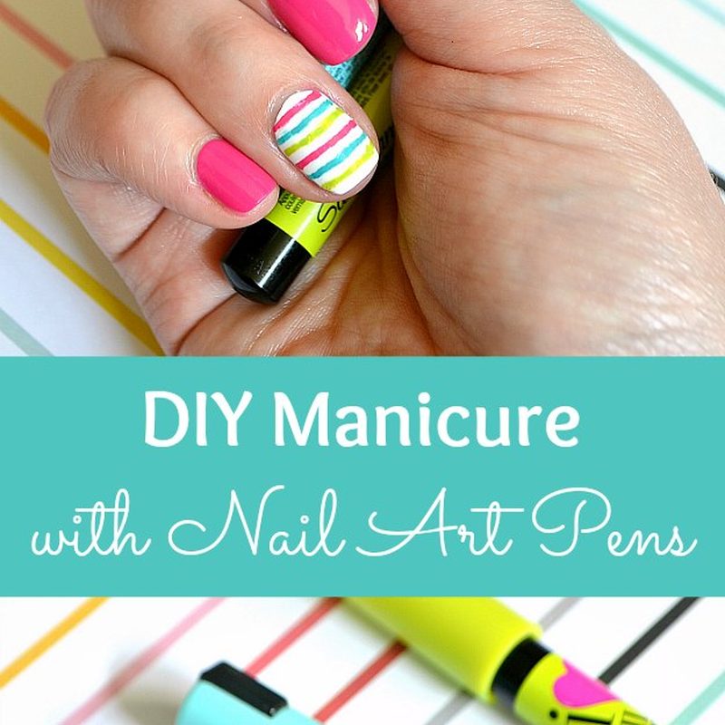 hand applying non toxic nail art pens on nails with base coat