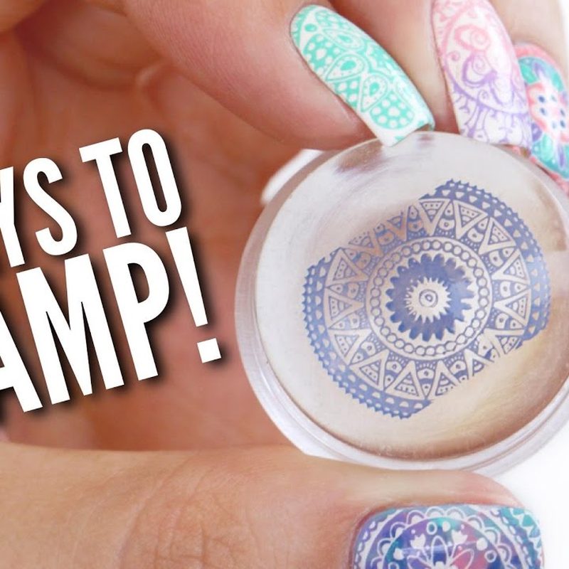Hands applying nail art stamping polish on a metal stamping plate