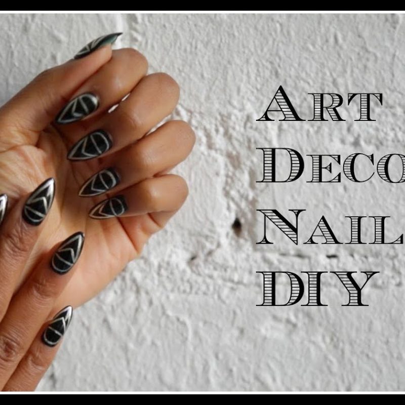 hands painting art deco nail art polish using fine brushes