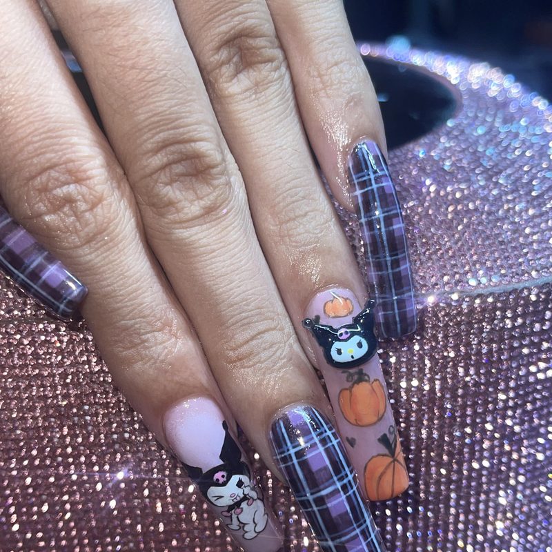 manicure artist applying fine lines with a nail art liner brush
