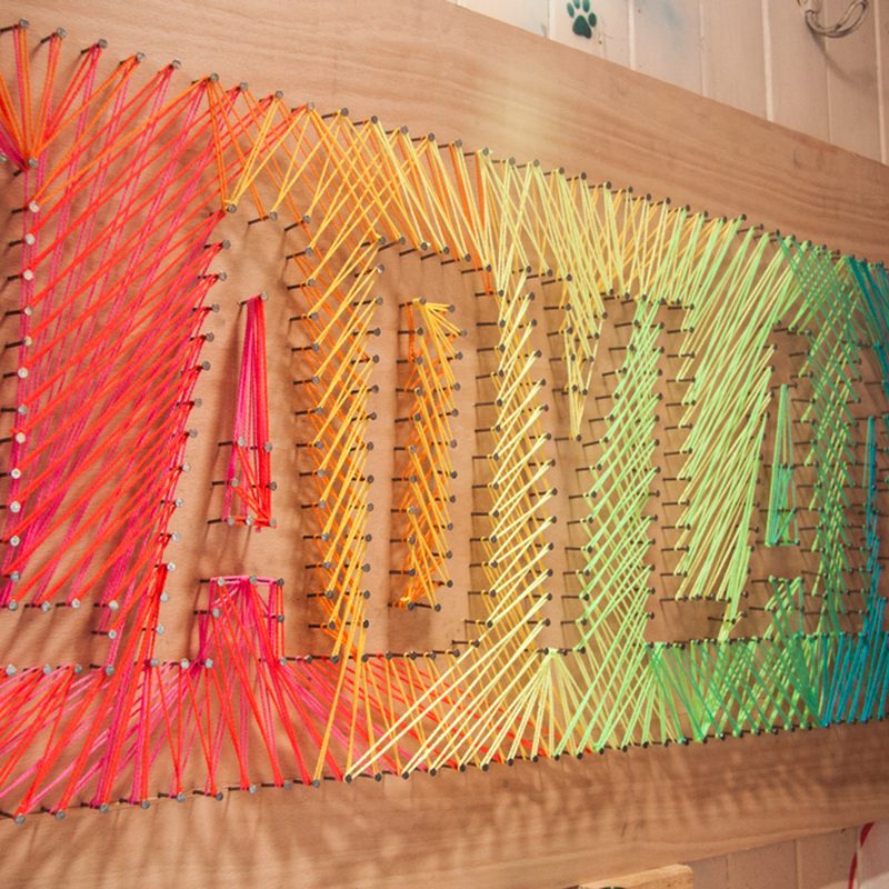 modern nail salon decor featuring string art with nails and wood