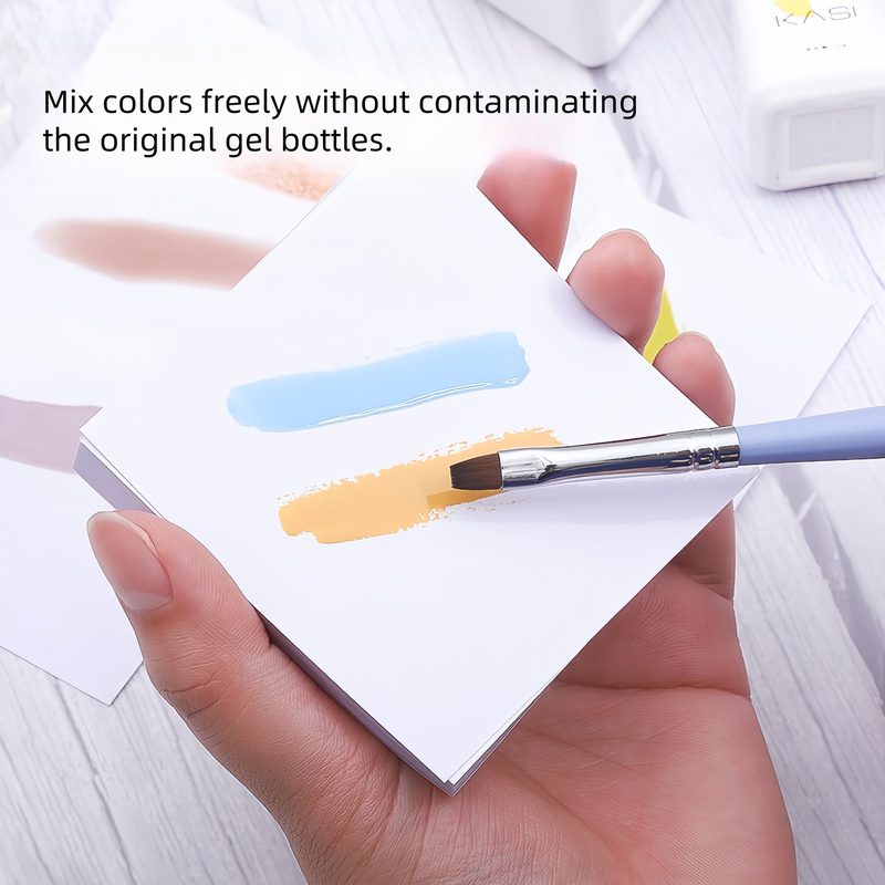 nail artist mixing nail polish colors on a disposable nail mat