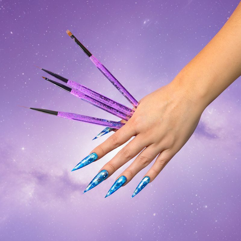 nail artist painting delicate lines with a nail art liner brush kolinsky