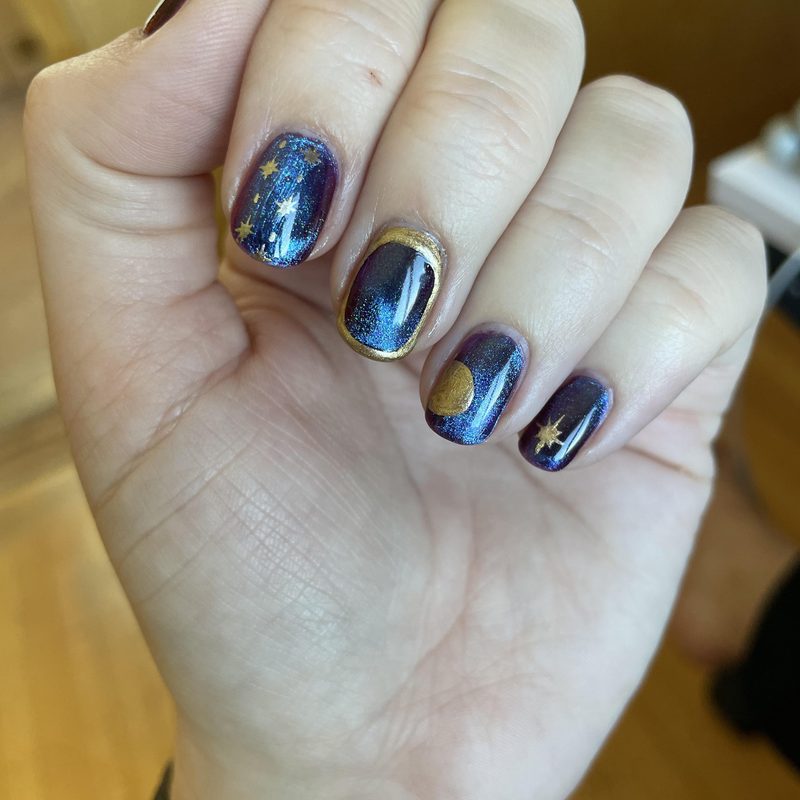 Nail artist using fine brush for gel nail polish nail art detailing