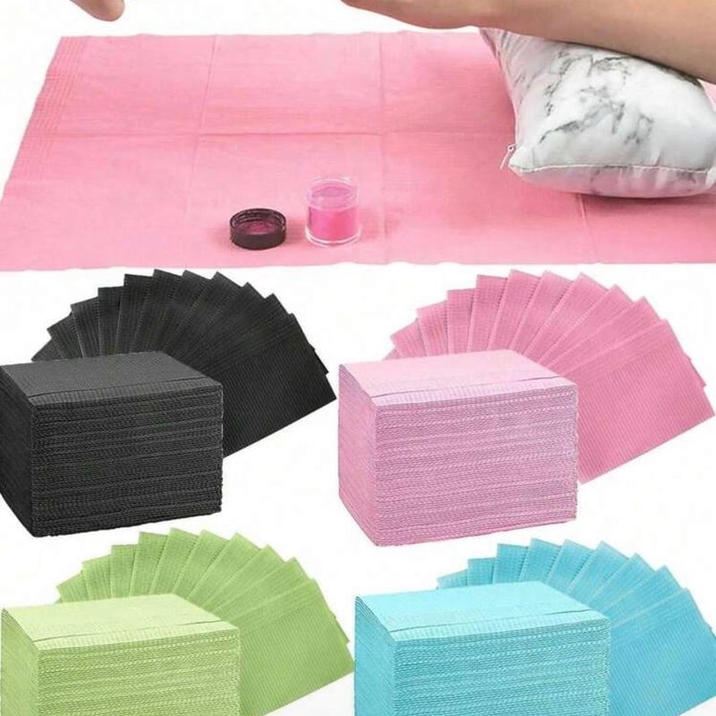 nail technician using a disposable nail mat to organize nail art supplies