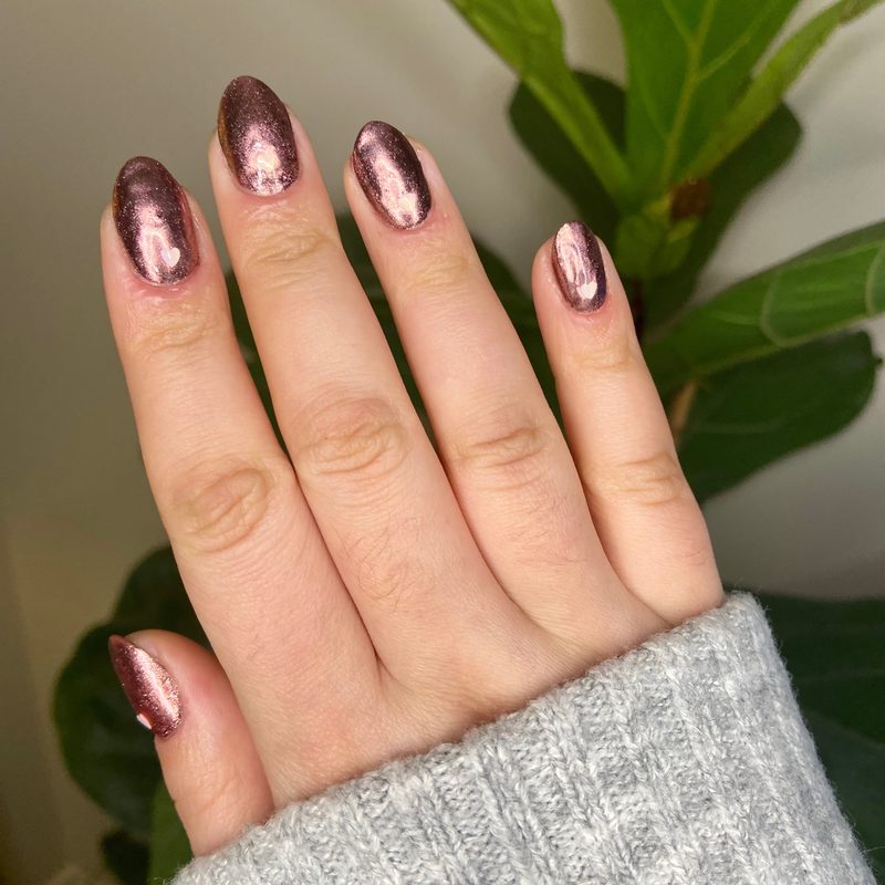 popular gel varnish mirror nails reflecting light in salon setting