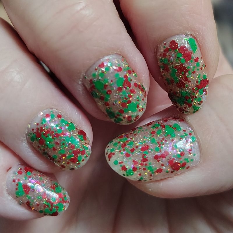 professional nail artist applying christmas glitter nail art in salon