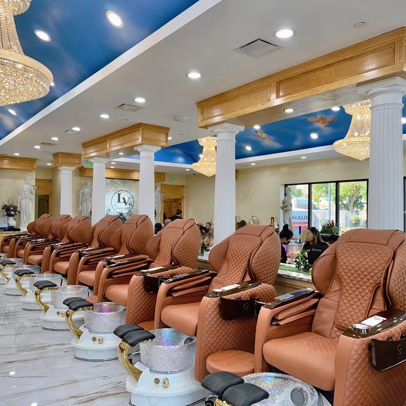 Professional nail technician performing manicure at a nail salon